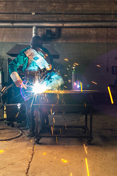istock Craftsman repairman is working with welding machine torch 522481300