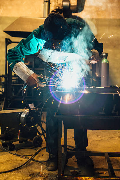 istock Craftsman repairman is working with welding machine torch 522481320