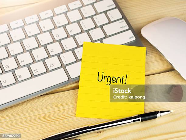 Urgent On Sticky Note On Work Table Stock Photo - Download Image Now - Activity, Adhesive Note, Adult