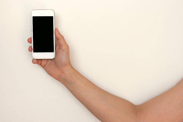 istock Hand holding mobile phone, smartphone, isolated on white 522482760