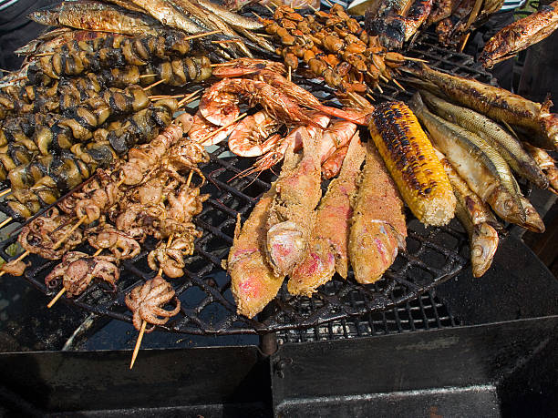 istock fried seafood, fish, shrimp, octopus, mussels on a barbecue grill 522482988