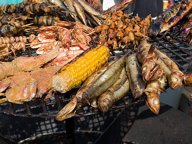 istock fried seafood, fish, shrimp, octopus, mussels on a barbecue grill 522483106