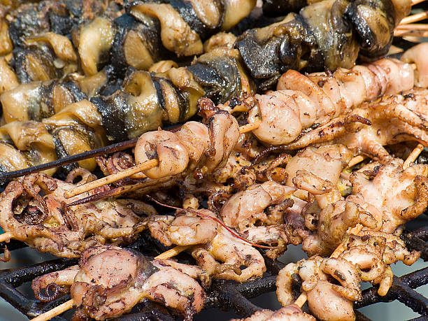 istock Appetizing delicious fried seafood, octopus, mussels on a barbecue grill 522483248