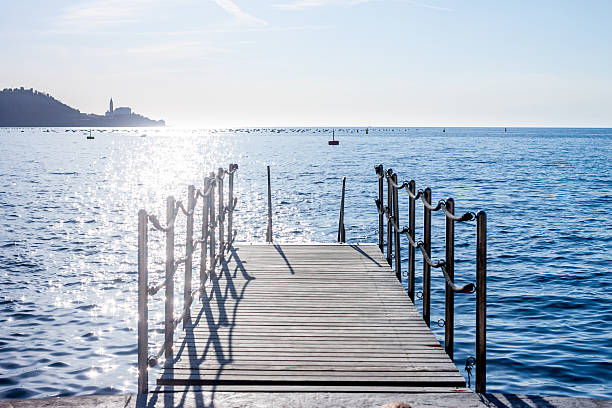 istock pier on background of sunset over sea 522483480