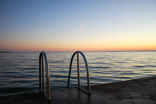Sunmmer evening at the bath place with a ladder into the water