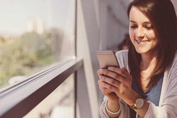 istock Happy woman texting in the office 522484298