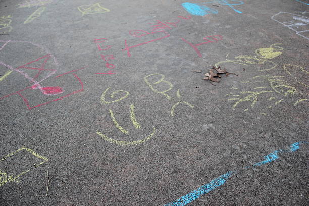 istock Sidewalk Chalk in the Fall - Girl Vs Boy 522484421