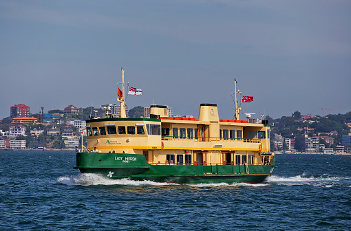Sydney,Australia - October 24,2014: One of Sydney's iconic ferries heads towards Taronga Zoo. The 28 vessels handle a total of 15 million passenger trips per year.