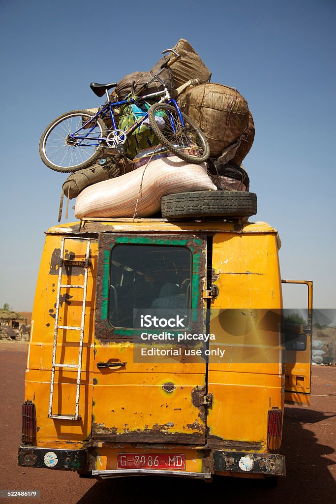 Old overloaded public transport with goods on the roof Djenné, Mali - January 2, 2011: Old overloaded public transport with goods on the roof of the bus. Transport public au Mali. Africa Stock Photo