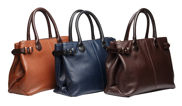 Set of three natural leather female purses different colour terracotta, brown and blue) isolated on white background