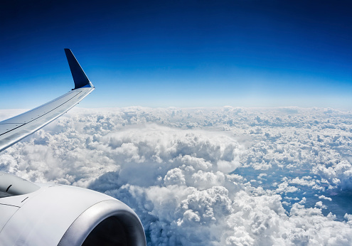 View from airplane window. Flight above the clouds