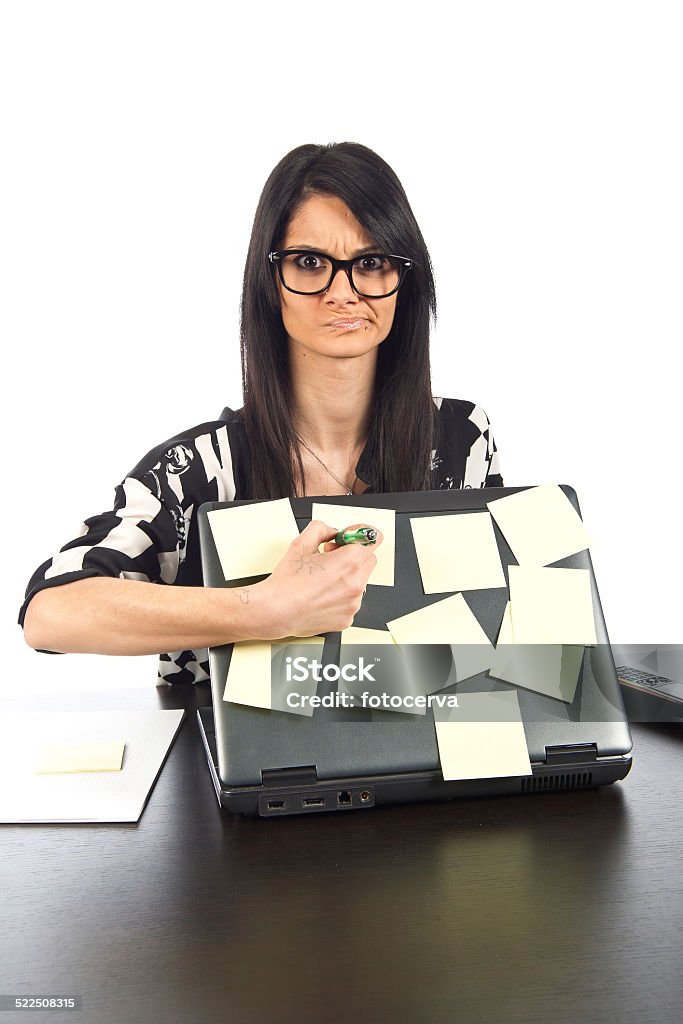 Remind me what I have to Girl at her desk with a lot of notes on her laptop Problems Stock Photo