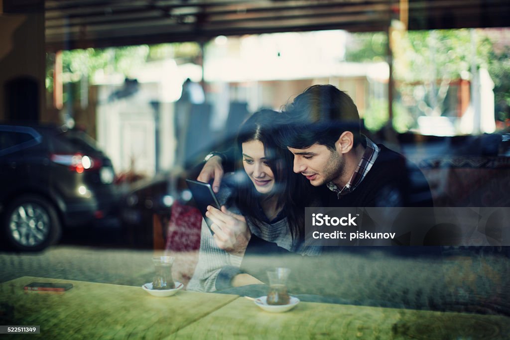 Turkish Couple in Cafe Use Tablet Shot taken in Istanbul, Turkey Adult Stock Photo