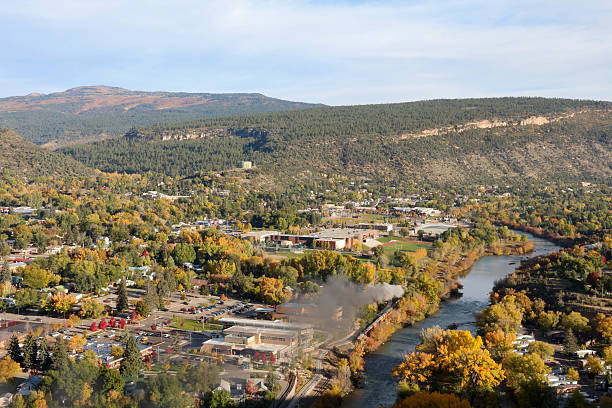 Durango, CO with the train next to the river View of Durango from the Rim Trail.  Narrow gage railroad running next to the Animas River flood plain photos stock pictures, royalty-free photos & images