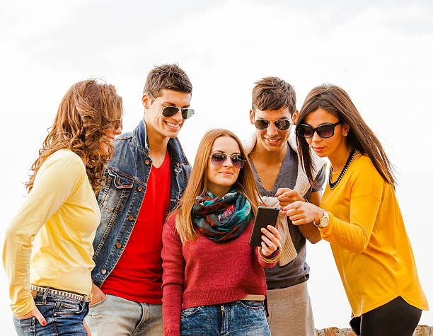 istock Friends looking into a smart phone 522511571