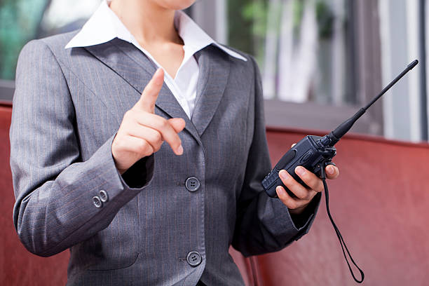 Businesswoman Talking on Walkie Talkie