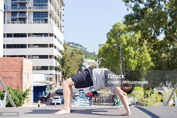 African Man Doing His Daily Yoga On The City Bridge Stock Photo - Download Image Now