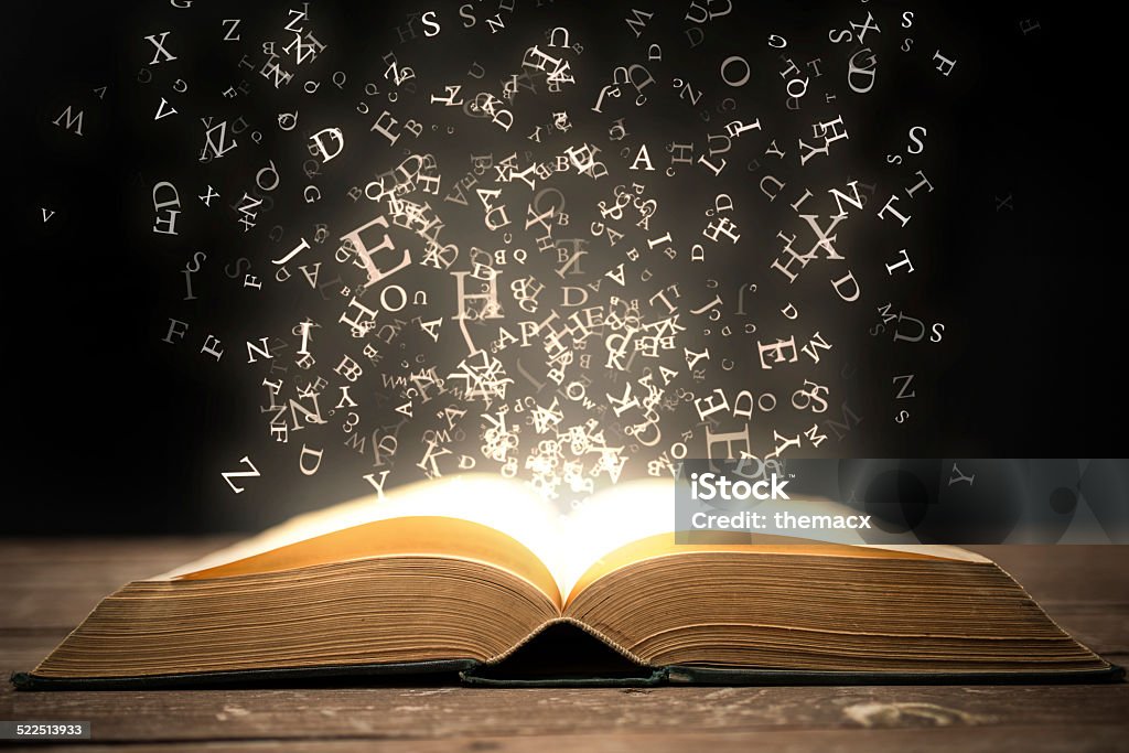 Book and glowing letters Open book and magical glowing letters. Book Stock Photo