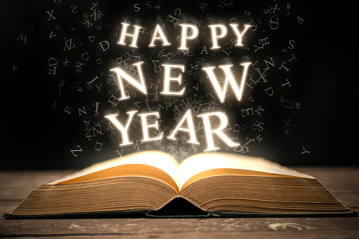 Happy New Year glowing letters in the book.