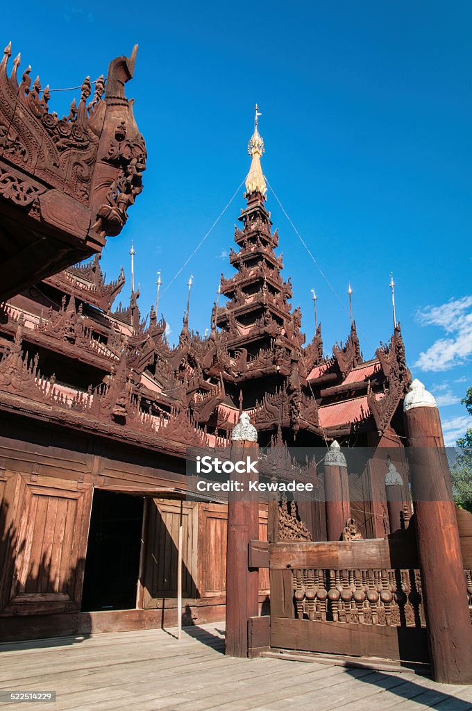 Teakwood monastery The ancient monastery locate in Mandalay Myanmar which the entire building is made out of teakwood and very beautiful handicraft all over the building. Architecture Stock Photo