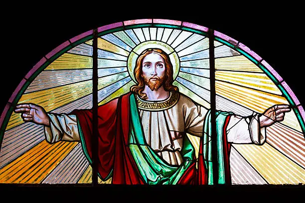 Stained glass window from 1854 of Jesus Christ with his arms outstretched, artist unknown, Czech Republic, full frame horizontal composition, copy space 