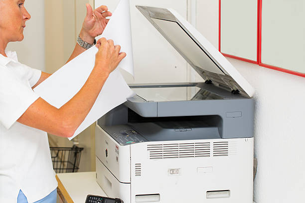 istock Nurse at work...using photocopier,copiing medical results 522515823