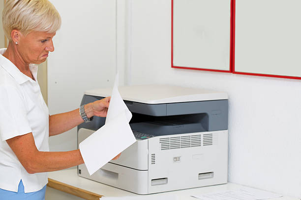istock Nurse at work...using photocopier,copiing medical results 522515827