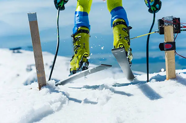Close-up of professional skier starting the race out of the starting gate