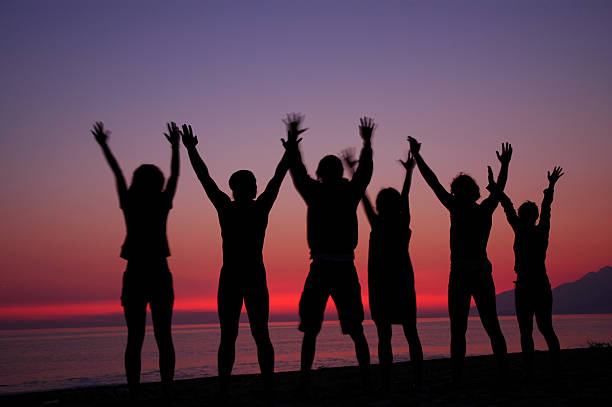 istock Group of people silhouettes in sunset 522522421