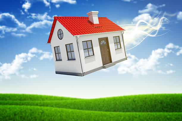 istock House is falling from the sky. Sky and grass on 522522967