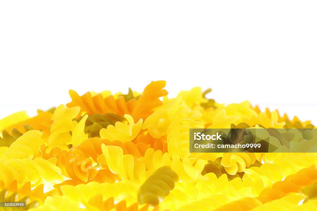 Raw Colored Rotini Pasta on White Background Raw italian colored rotini pasta isolated on a studio shot over white background Carbohydrate - Food Type Stock Photo