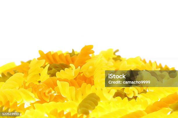 Raw Colored Rotini Pasta On White Background Stock Photo - Download Image Now - Carbohydrate - Food Type, Close-up, Extreme Close-Up