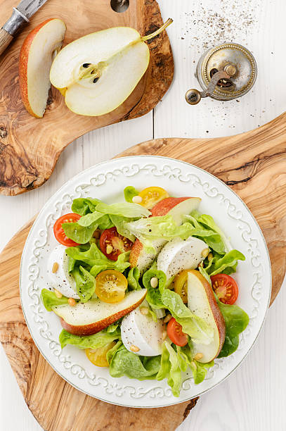 Green salad with tomatoes, mozzarella and pear stock photo