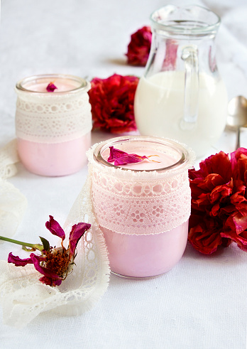 Rose flavor Greek yogurt in a glass jar decorated with lace