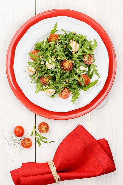 Salad with arugula, tomatoes cherry and mozzarella stock photo