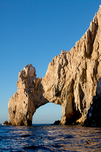 Ocean waves splashing on the famous natural arch at Lands End in Cabo San Lucas, Mexico