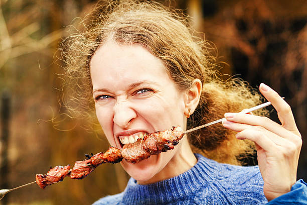 istock woman eating kebab 522527183