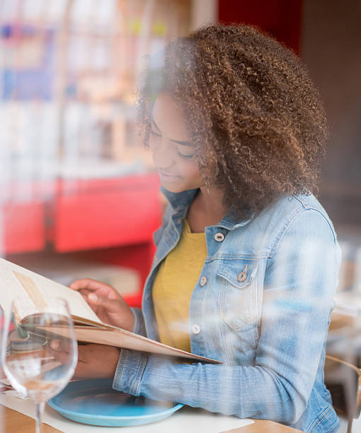 istock Woman reading the menu at a restaurant 522527452