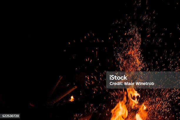 Sparks Bounce Off From A Bonfire At Night Stock Photo - Download Image Now - Fire - Natural Phenomenon, Bonfire, Sparks