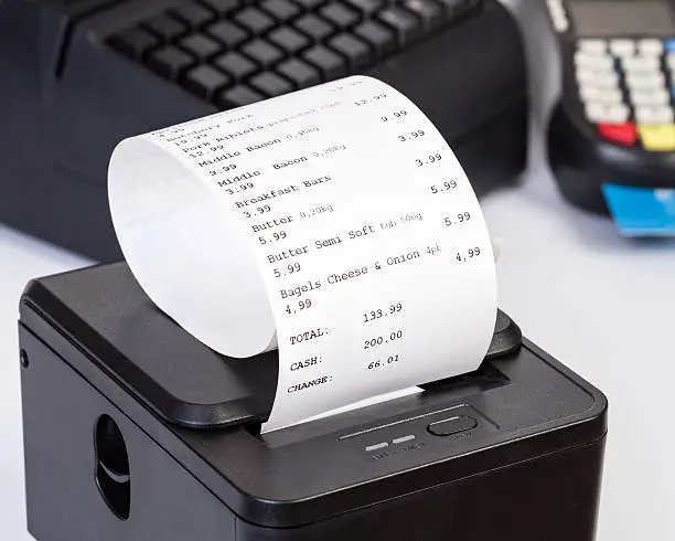 Photo of Receipt Printer with paper shopping bill.