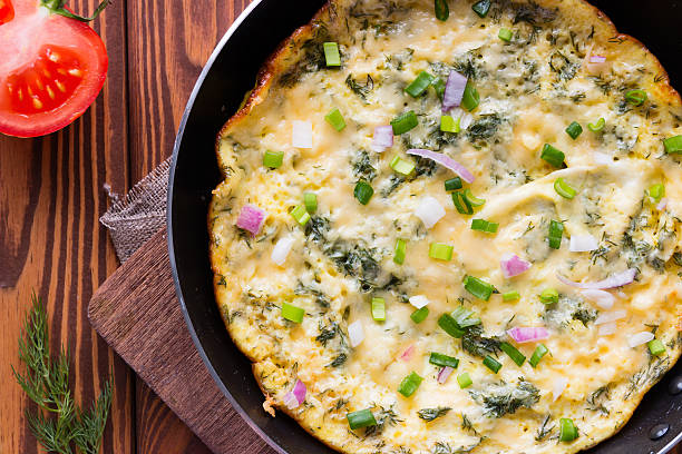 istock Egg omelet in a pan on a cutting board close-up 522534874