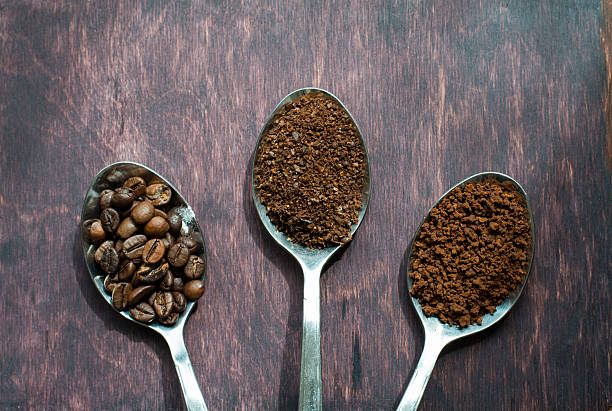istock Three stages of spoons in coffee - beans, ground, instant 522537334