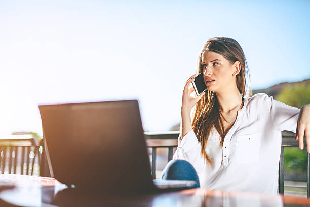 istock girl talking on smartphone and using laptop 522537942
