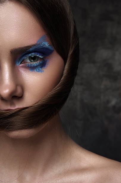 istock Half Face of beauty Model with blue Makeup on Eyes 522537960