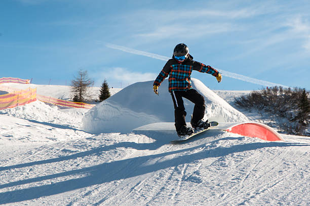 istock freestyle snowboarder with helmet in snowpark 522538022