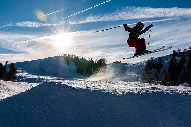 istock Little skier performs jump in the snow 522538190