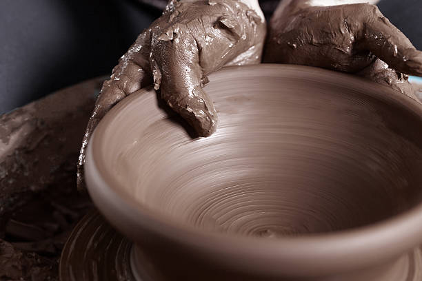 Close-up of potter's hands Close-up of potter's hands with the product on a potter's wheel homemade pottery wheel stock pictures, royalty-free photos & images