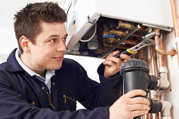 istock Male Plumber Working On Central Heating Boiler 522539168