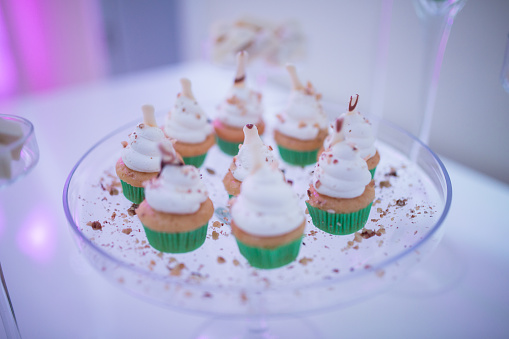 Delicious wedding cupcakes on glass dish