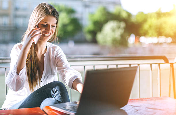 istock young girl using laptop and smartphone 522540278